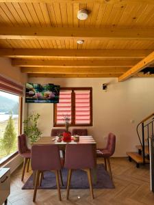 a dining room with a table and chairs at Stara pruga Jaz 2 in Višegrad