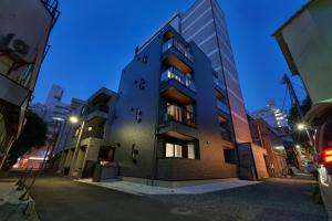 a building on a city street at night at Yamanote walk for 8mins, New APT on Local shopping street in Tokyo