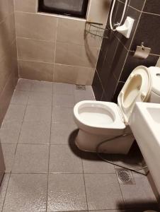 a bathroom with a toilet and a sink at Hyve Soho Suite - Netflix in Cyberjaya