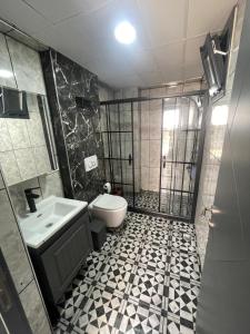 a bathroom with a shower and a toilet and a sink at Spacious and modern apartment with a view in Gökçeada +10 photos