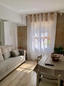 a living room with a couch and a coffee table at Brisa Azul in Moaña