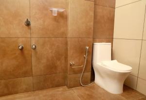 a bathroom with a toilet and a shower at J TEN Residency in Meenangadi +24 photos