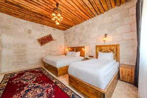 Postel nebo postele na pokoji v ubytování MDC Cave Hotel