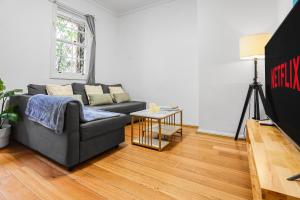 a living room with a couch and a table at 2 Bedroom House Darling Harbour Good for 6 Guests in Sydney