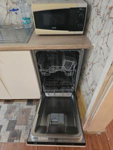 an open oven with a microwave on a counter at Garden guest house in Tirana +3 photos