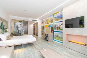 a living room with a couch and a tv on a wall at Max Motel - Art Gallery Room in Druento