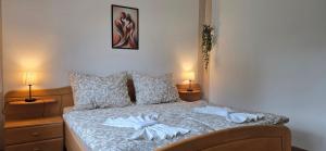 a bedroom with a bed with two towels on it at Wellness Apartment  +20 photos