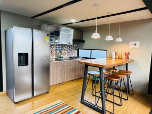 a kitchen with a wooden table and a refrigerator at Glamping Desierto Santa María 2 in Villa de Leyva +6 photos