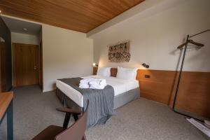 a hotel room with a bed with towels on it at Samzeo Tusheti in Omalo