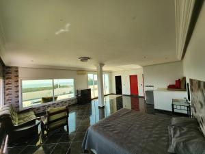 a bedroom with a bed and a couch and a table at Villa BleuBlanca Tangier in Tangier
