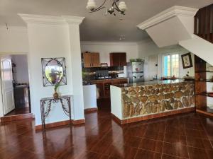 a living room with a stone wall in a kitchen at Villa BleuBlanca Tangier in Tangier