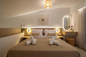 Ένα ή περισσότερα κρεβάτια σε δωμάτιο στο Aladdin Luxury Suites With Shared Pool +43 φωτογραφίες