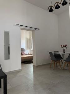 a living room with a table and a dining room at L&S Rooms in Monopoli