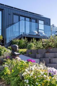 a glass house with a statue in the garden at Ocean breeze homestays 1 in Bicheno