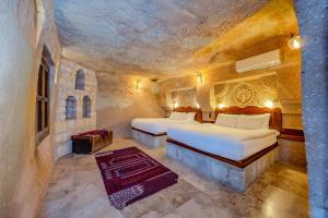 Postel nebo postele na pokoji v ubytování MDC Cave Hotel