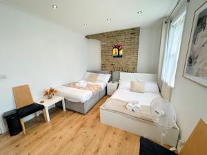 a living room with a bed and a couch at 11 Guests - 6min Drive to the Wembley Stadium in London
