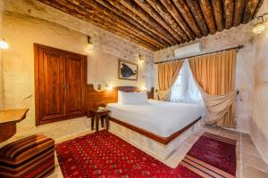 Postel nebo postele na pokoji v ubytování MDC Cave Hotel