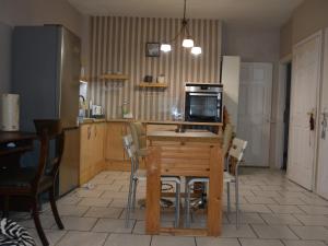 a kitchen with a table with a computer on it at Kelly'sHouse in Kavala