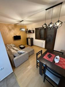 a living room with a couch and a table at Apartman Stefan Zlatibor in Zlatibor +27 photos