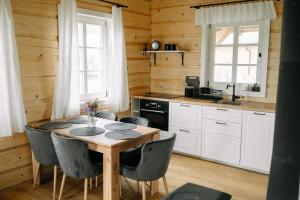 a kitchen with a table and chairs in a room at Chalupa na Políčku in Hanička