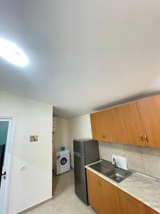 a kitchen with a sink and a refrigerator at Dori Apartment in Vlorë