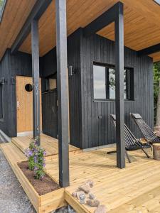 a house with a wooden deck with a porch at Villa Anttoora in Pori