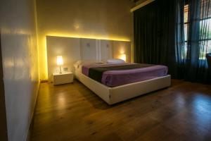 A bed or beds in a room at Spa Resort Fonte Alla Lepre