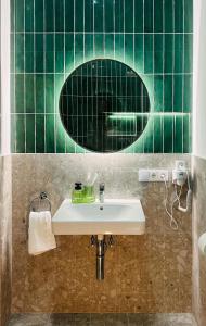 a bathroom with a sink and a mirror at Villa Romana Apartments in Baden