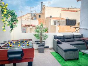 a patio with a table and a couch and a chessboard at Major by Unik Vacation in Tarragona