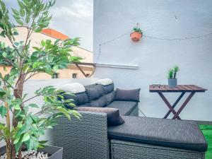 a patio with a couch and a table with plants at Major by Unik Vacation in Tarragona +34 photos