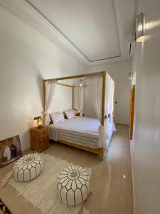 a bedroom with a bed with a canopy at Kasbah ben hamou in Nkob