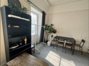 a living room with a table and a dining room at Edinburgh Central Cozy Flat in Edinburgh