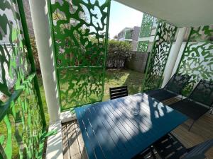 a balcony with a blue bench on a patio at Joli appartement rénové La Rochelle in La Rochelle