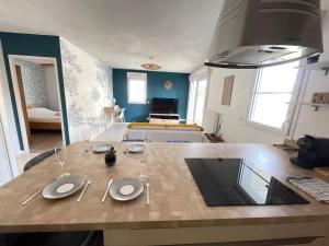 a kitchen with a wooden table with glasses on it at Joli appartement rénové La Rochelle in La Rochelle