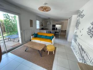 a living room with a couch and a table at Joli appartement rénové La Rochelle in La Rochelle +18 photos