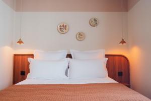 a bedroom with a bed with white pillows at LALA Hôtel in Paris