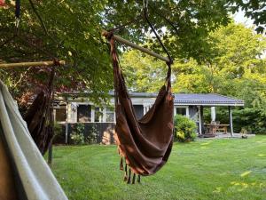 2 hamacs suspendus à un arbre dans une cour dans l'établissement Lovely Cottage Close To Beach And Nature, à Yderby 12 autres photos