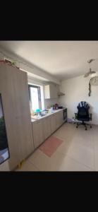 a room with a kitchen and a chair in it at Bugibba in Bugibba +10 photos