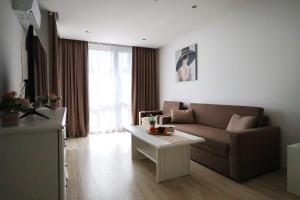 a living room with a couch and a table at Stylish Paradiso Apartment 206 in Nesebar