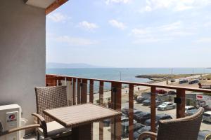 a balcony with a table and chairs and the ocean at Stylish Paradiso Apartment 206 in Nesebar