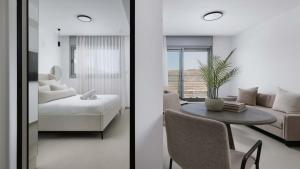 a living room with a couch and a table with a plant at Boutique apartment with spectacular view of the Eilat mountains in Eilat +25 photos