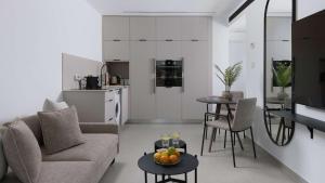 a living room with a couch and a table at Boutique apartment with spectacular view of the Eilat mountains in Eilat