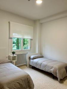 a bedroom with two beds and a window at Miresibilbao - Residencia Universitaria in Bilbao +69 photos