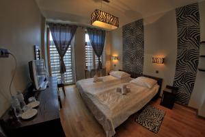 a bedroom with a large bed and a tv at Hotel Polonia in Ostrów Wielkopolski