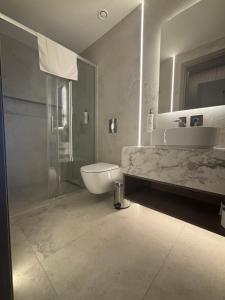 a bathroom with a tub and a sink and a shower at Tuck Inn in Larnaca