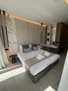 a bedroom with a large bed with towels on it at Tuck Inn in Larnaca