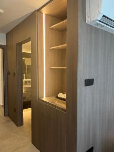 a room with a wall with a cabinet with shelves at Tuck Inn in Larnaca