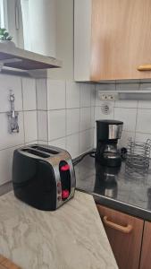 a toaster sitting on top of a kitchen counter at Himos,Halli, Vehkaojan viihtyisä yksiö,A7 in Halli +10 photos