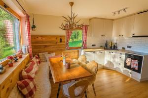 a kitchen with a table and a dining room at Hänsles Hütte in Winklern