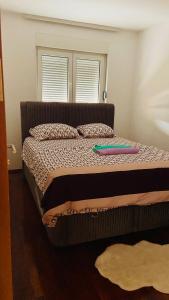a bed with a frisbee sitting on top of it at One bedroom apartment Podgorica in Podgorica